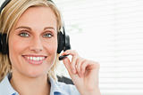 Close up of a smiling businesswoman with headset looking