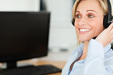 Portrait of a smiling businesswoman with headset working with co