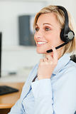 Portrait of a smiling businesswoman with headset looking 