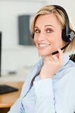 Portrait of a smiling businesswoman with headset looking