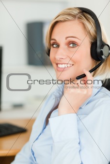 Portrait of a smiling businesswoman with headset looking