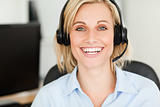 Close up of a blonde woman wearing headset looking into camera