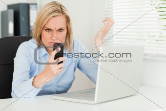 Businesswoman glaring at her phone