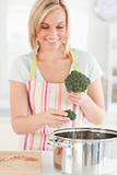 Close up of a woman cooking broccoli 