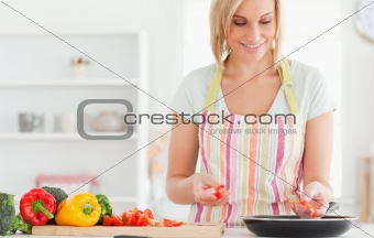 Close up of a woman frying peppers