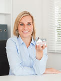 Gorgeous blonde businesswoman showing miniature house 
