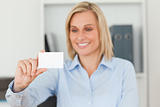 Blonde businesswoman holding a card