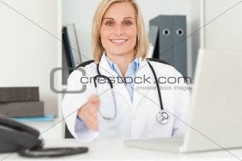 Blonde smiling doctor giving hand