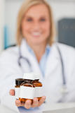 Smiling blonde doctor holding medicine
