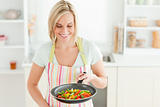 Woman looking at pan filled with peppers
