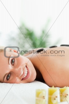Close up of a blonde woman having a stone therapy