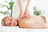Blonde woman relaxing on a lounger during massage