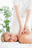 Gorgeous smiling woman relaxing on a lounger during massage