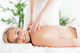 Cute woman relaxing on a lounger during massage