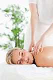 Good looking woman relaxing on a lounger during massage 