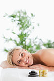 Smiling blonde woman lying on a lounger 