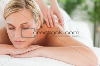 Close up of a smiling woman relaxing with eyes closed on a lounger