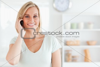 Young woman on the phone looking into the camera