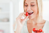 Woman enjoying eating strawberries