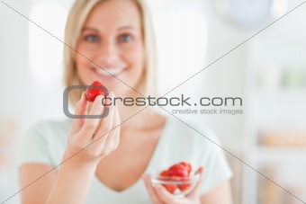 Close up of a woman enjoying eating strawberries 