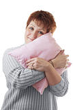 Happy woman hugs pink pillow
