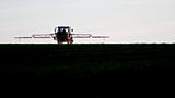 tractor spraying agricultural pesticide