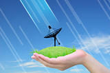 satellite dish on green grass in women hand