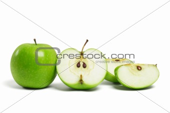 Whole green apple and cut pieces