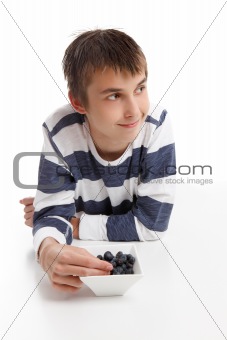 Boy eating blueberries