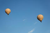 two cream white balloons blue sky