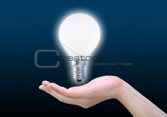 light bulb in women hand on dark