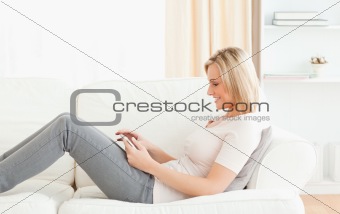 Blonde woman using a tablet computer