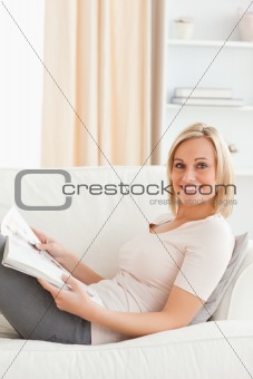 Portrait of a young woman with a magazine