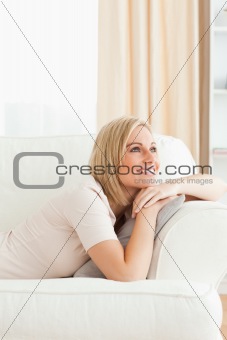 Portrait of a beautiful woman lying on her sofa