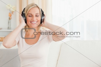 Blond-haired woman listening to music
