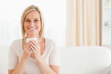 Smiling woman holding a cup of tea