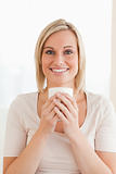 Portrait of a smiling woman holding a cup of coffee
