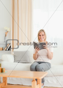Portrait of a blond-haired woman with a book