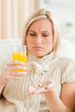 Sick woman showing pills