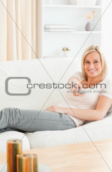 Portrait of a smiling woman using a remote