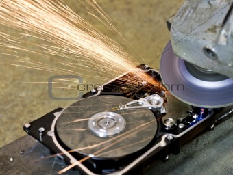 grinder working on open hard drive
