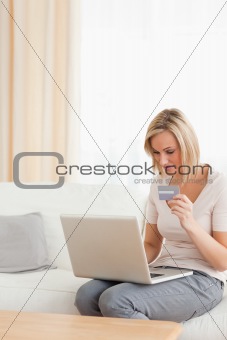 Portrait of a focused woman shopping online
