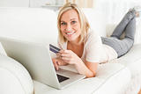 Cute woman using a notebook to buy online
