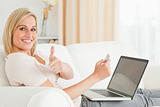 Smiling woman paying her bills online