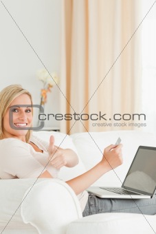 Potrait of a smiling woman paying her bills online
