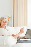 Potrait of charming woman paying her bills online