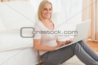 Portrait of a fair-haired woman with a laptop