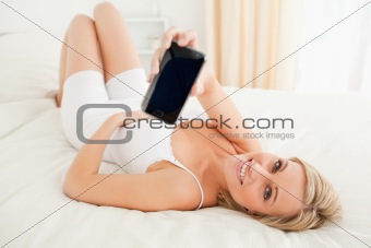 Cute woman showing her smartphone