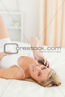 Portrait of a blonde woman making a phone call