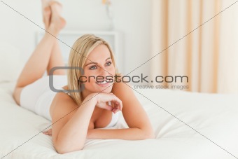 Close up of a smiling woman lying on her bed